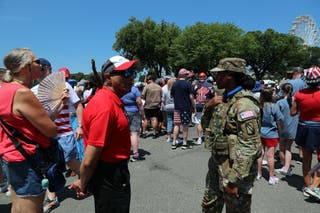 People wait to enter the National Mall ahead of tonight's Fourth of July celebrations